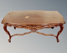 A Continental beech low coffee table with under stretcher