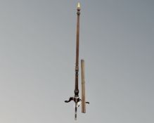 A beech wood standard lamp on tripod base together with a set of antique brass stair rods