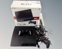 A Playstation III together with controller and three games