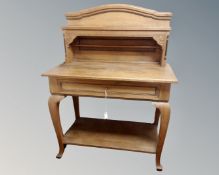 An early 20th century oak buffet side table