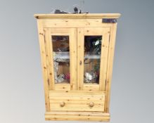 A pine double door glazed cabinet converted to a vivarium with accessories