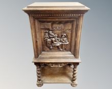 A 20th century Scandinavian oak cabinet with carved panel door