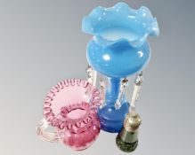 A Victorian cranberry glass jug together with a Victorian blue glass lustre and green glass sifter