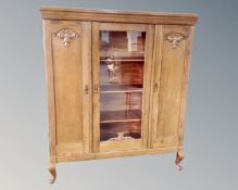 An early 20th century oak glazed door bookcase