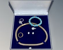 A costume necklace in case together with further bracelet,