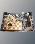 A crate containing a marquetry chess board, boxwood chess pieces, cast iron door stop,