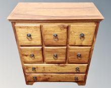 A mango wood eight drawer chest