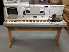 A Yamaha portable Grand DGX-620 electric keyboard with lead and foot pedal