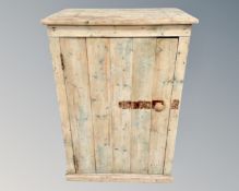 A vintage pine single door cabinet