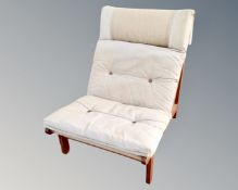 A Scandinavian pine framed low chair with canvas seat