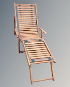 A teak steamer garden armchair with footrest