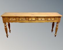 A pine farmhouse style five drawer hall table