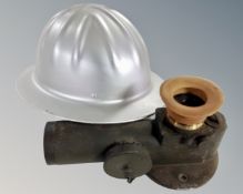 An aluminium safety hardhat together with a World War II periscope.