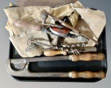 A vintage horse tail docking tool together with a collection of vintage hand tools and a leather