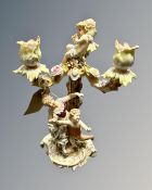 A continental encrusted candelabrum surmounted with figures.