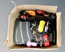 A box of Scalextric track,