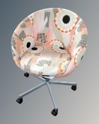 A Retro style tub chair on castors