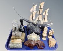 A tray of oriental wares including figures, two seals, boat with horn sails.