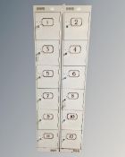 A pair of narrow metal six door lockers with eleven keys