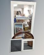An oval Victorian style wall mirror together with three painted framed mirrors