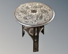 An ebonised carved circular Arts and Crafts occasional table