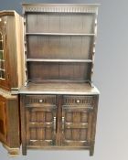 A Welsh dresser in oak finish together with an oak gateleg table and four wheel backed chairs