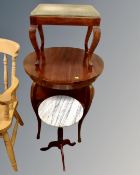 A circular two-tier beech occasional table together with a footstool and marble topped wine table