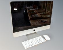 An Apple iMac computer with keyboard and mouse