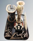 A tray containing an alabaster vase, carved fish, carved wooden figures etc.