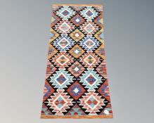 A Chobi Kilim runner, 142cm by 68cm.