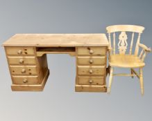 A pine twin pedestal computer desk together with a pine farmhouse armchair