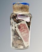 A jar of a large quantity of assorted foreign coins and banknotes