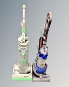 A Dyson DC25 ball vacuum together with DC04 upright vacuum