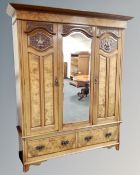 A 19th century mahogany and walnut three piece bedroom suite comprising of a double door wardrobe