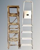 A set of aluminium folding steps together with a further set of folding steps.