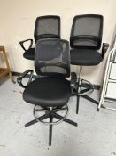 Three adjustable draughtman's swivel armchairs.