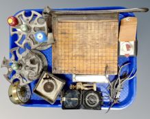 A tray containing a pair of cast iron stands, vintage hand tools, a pocket compass, brass figure,
