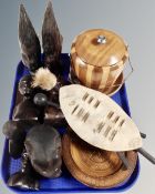 A tray of tribal carvings, miniature zulu style shield, dishes,