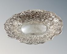 A silver embossed dish, Birmingham marks, width 23cm.