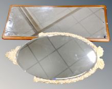 A mid century frameless mirror mounted on teak board together with further oval bevelled wall