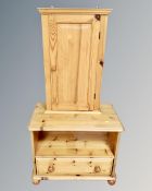 A pine wall cabinet together with a pine television stand fitted with a drawer.