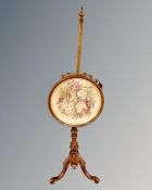 A Victorian mahogany pole screen.