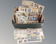 A box of hundreds of assorted world stamps mounted on card