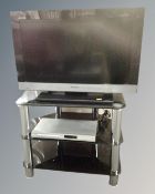 A Sony Bravia 26 inch LCD TV on stand together with Philips DVD player