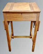 A 20th century flap sided clerk's desk on raised legs.