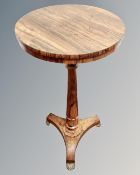 A William IV rosewood circular tripod wine table, on brass paw feet, diameter 40cm.