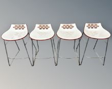 A set of four Italian Calligaris Connubia jam orange breakfast bar stools on metal legs.