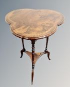 A Victorian inlaid rosewood clover occasional table, on tripod legs.