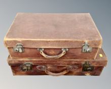 Two vintage hand stitched leather luggage cases together with a wrought iron framed wall mirror.