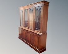 A reproduction mahogany four door glazed bookcase fitted with cupboards below, width 194cm,